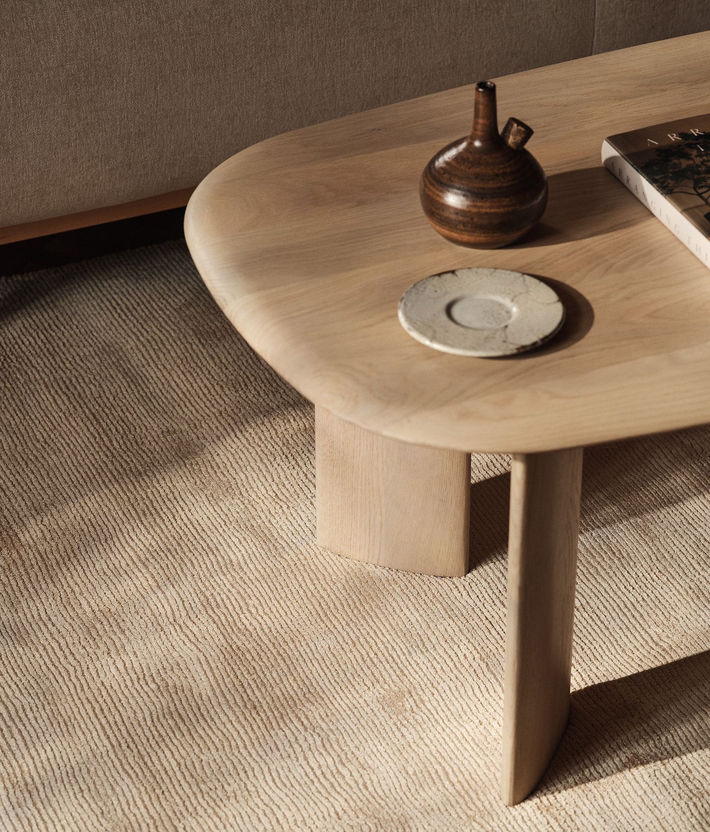 Aggie dining table with curved edges in a natural wood finish.