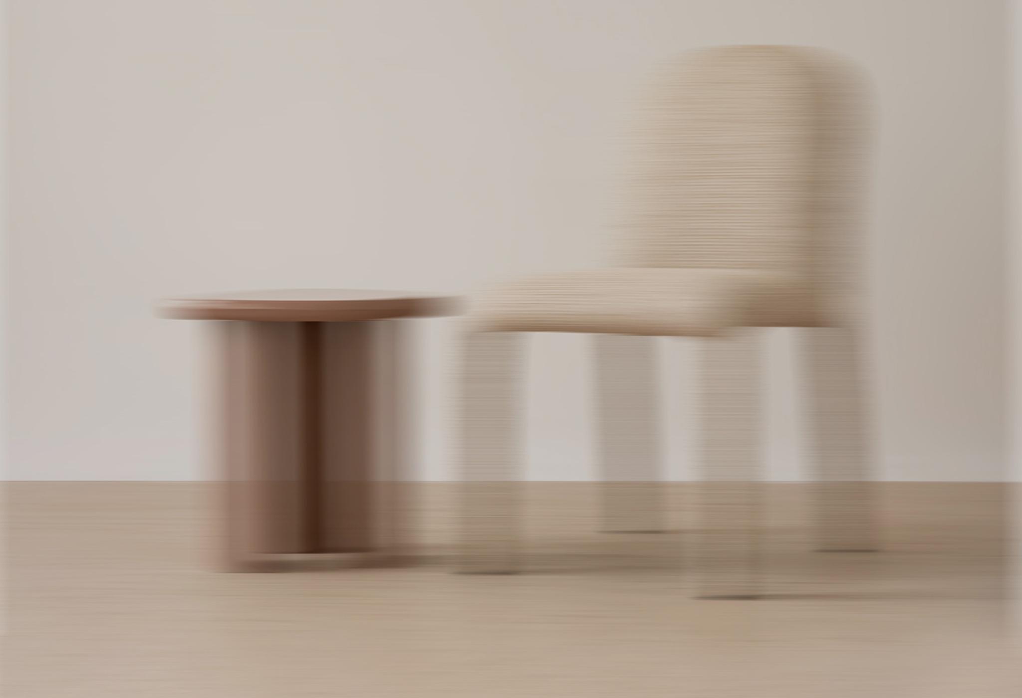 Micadoni Livraison rapide – chaise et petite table floues en studio neutre, symbole d’un envoi rapide.