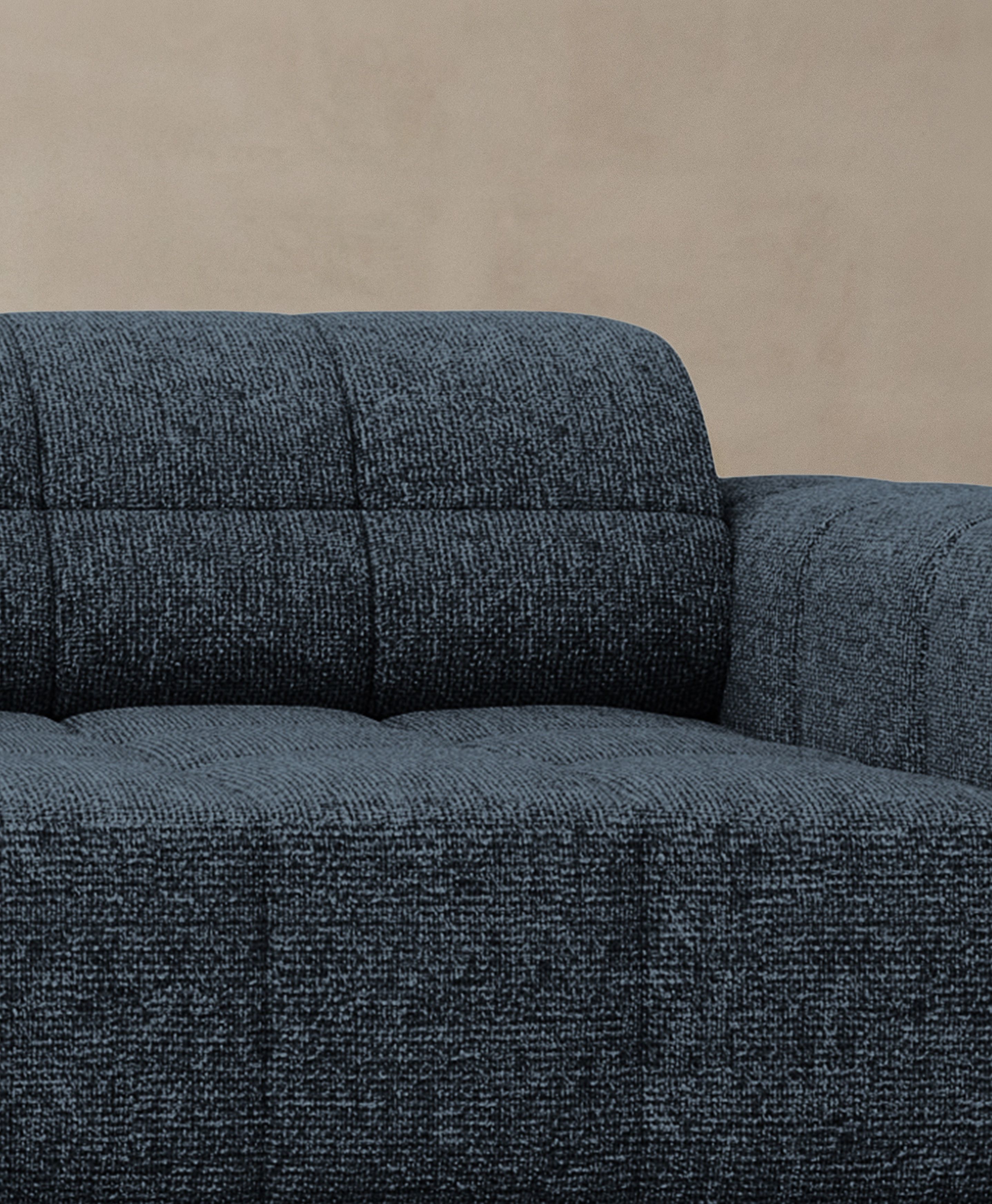  Close-up of Jennifer sofa in dark textured fabric with square stitching and deep seat – Micadoni furniture