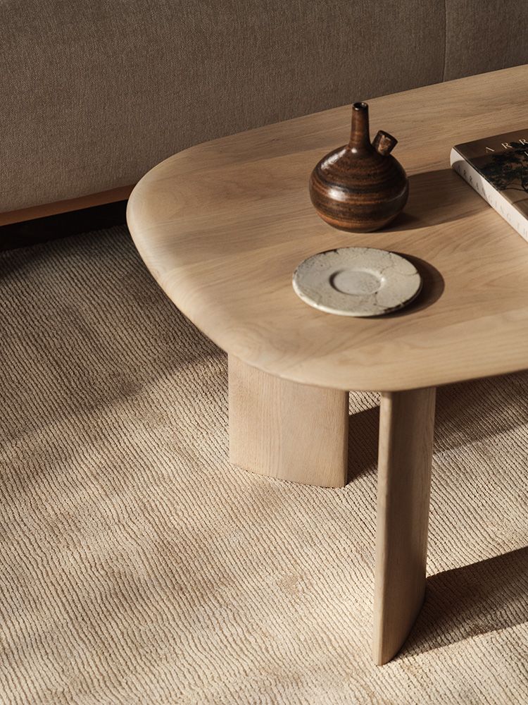 Aggie dining table with curved edges in a natural wood finish.